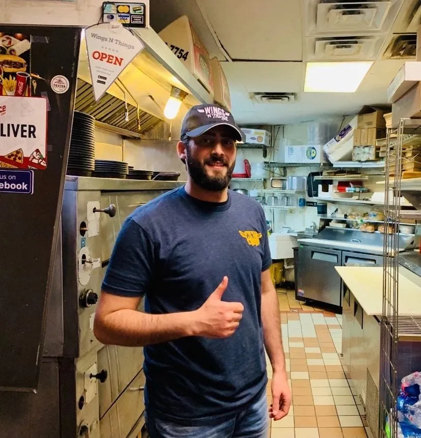 Team member giving a thumbs up in the kitchen